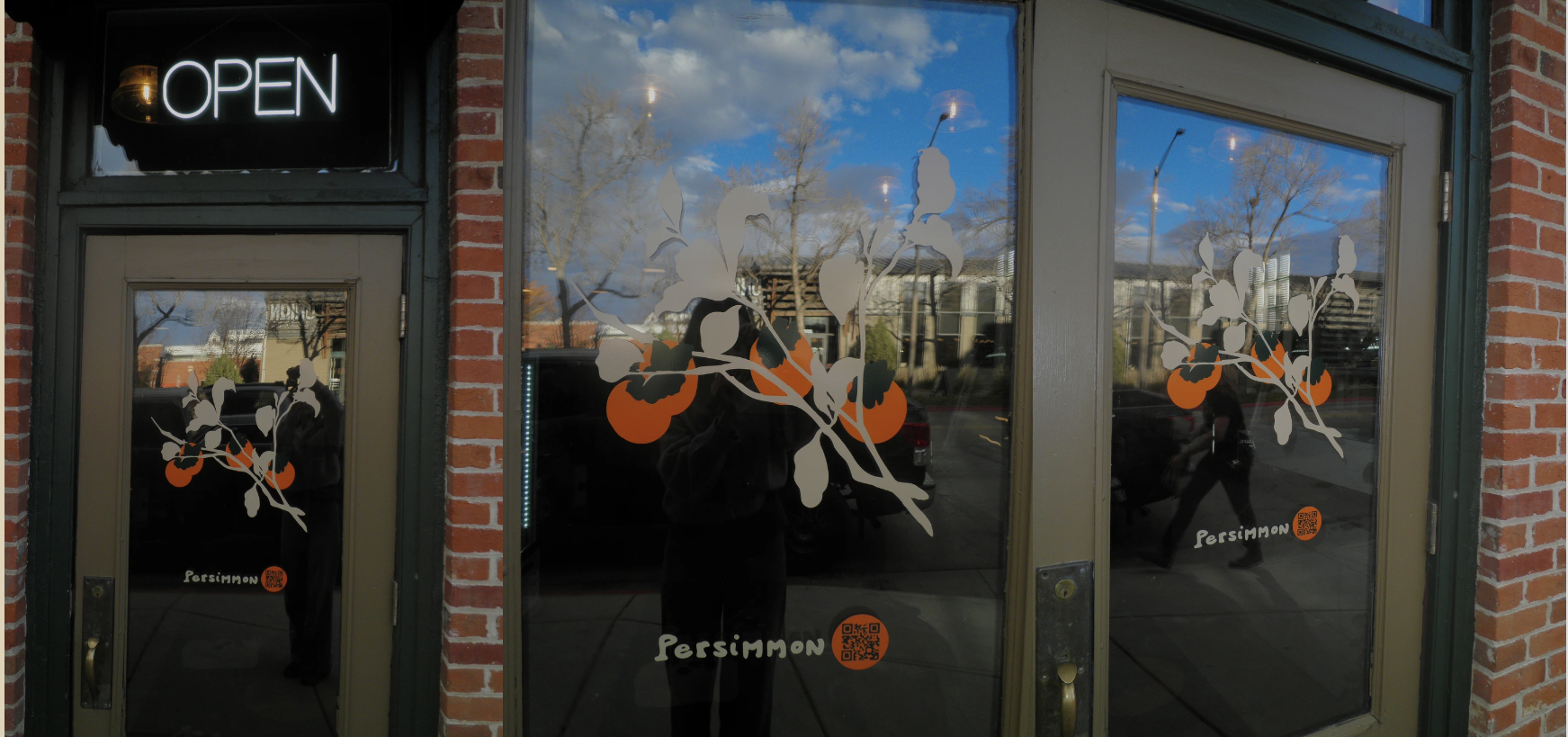 Persimmon storefront with custom window decals and wayfinding